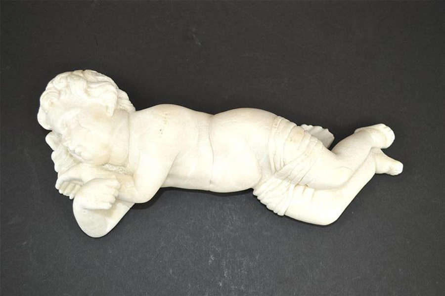 Antique sculpture of a sleeping cherub