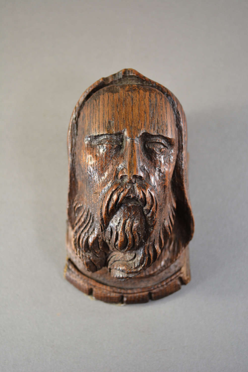 Carved oak hooded bearded man head corbel