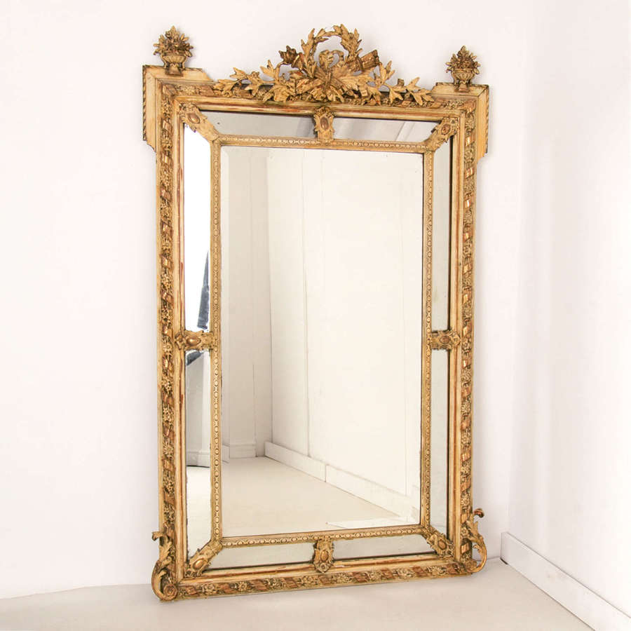 A French antique crested margin mirror in original parcel-gilt