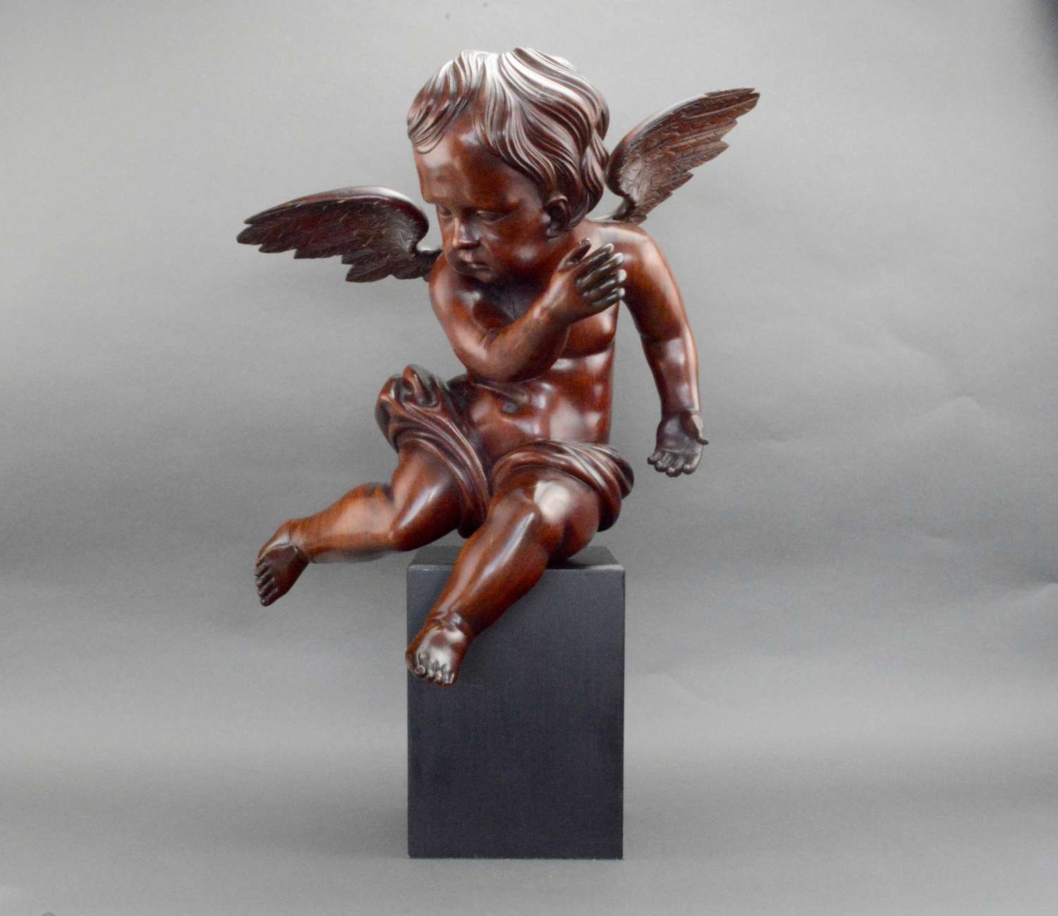 A large hand carved cherub in solid limewood ,Italy.
