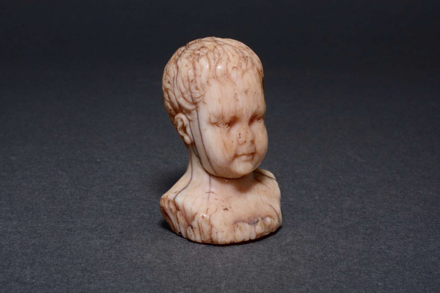 A wonderfully tactile antique bust of a child.