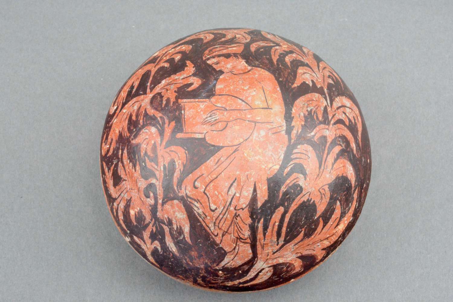 An ancient Greek decorated pottery pot lid or bowl.