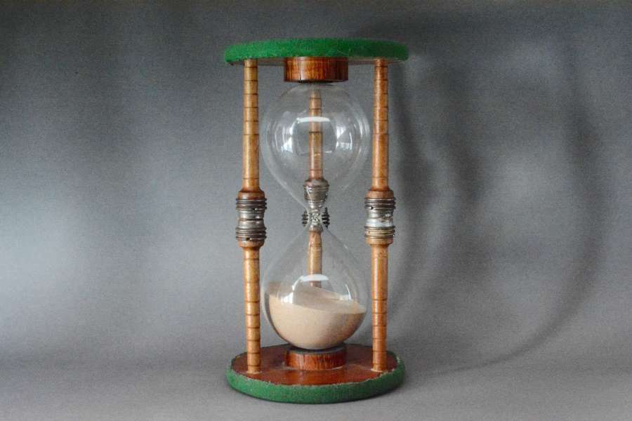 Hour glass sand timer fashioned from a large mill spindle