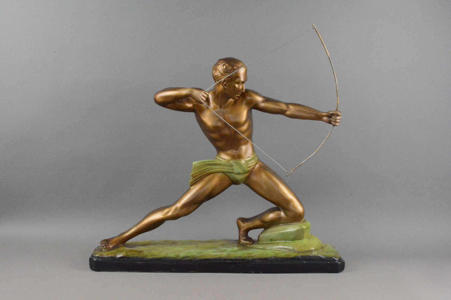 An impressive Art Deco mantle figure depicting a semi-clad male hunter