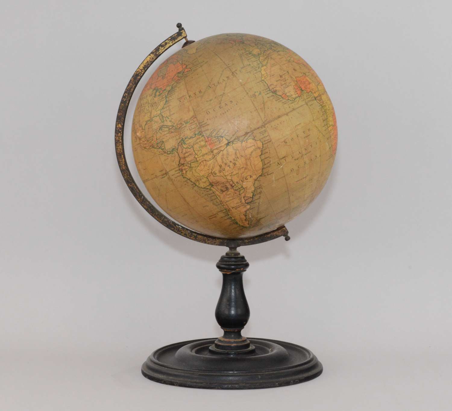 A Phillips 9 inch Terrestrial world globe on ebonised wooden stand.