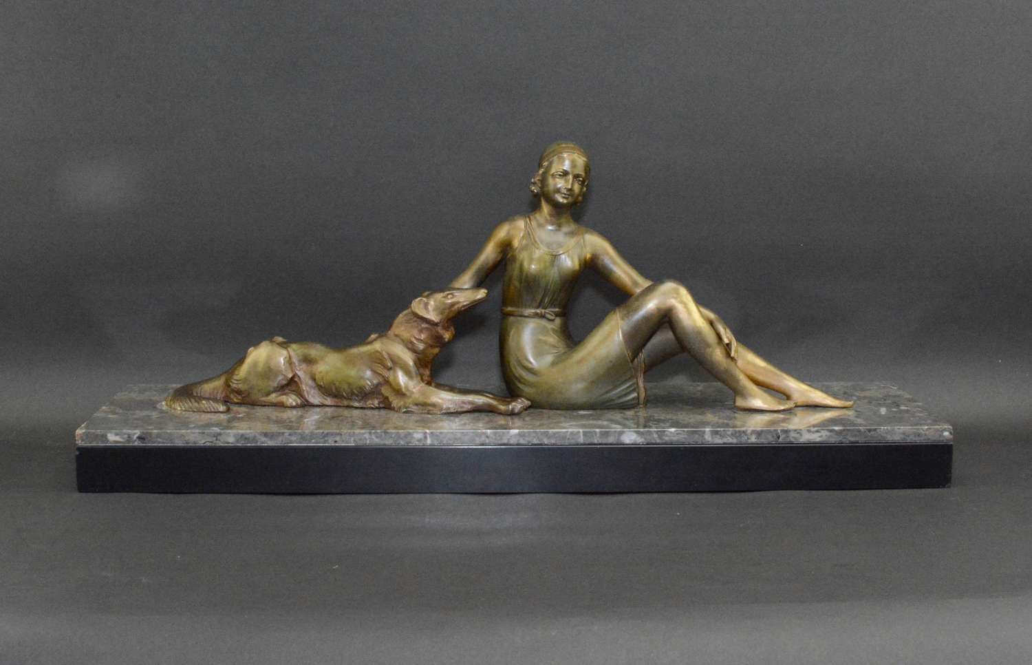Art Deco period figural sculpture a seated lady with Borzoi dog